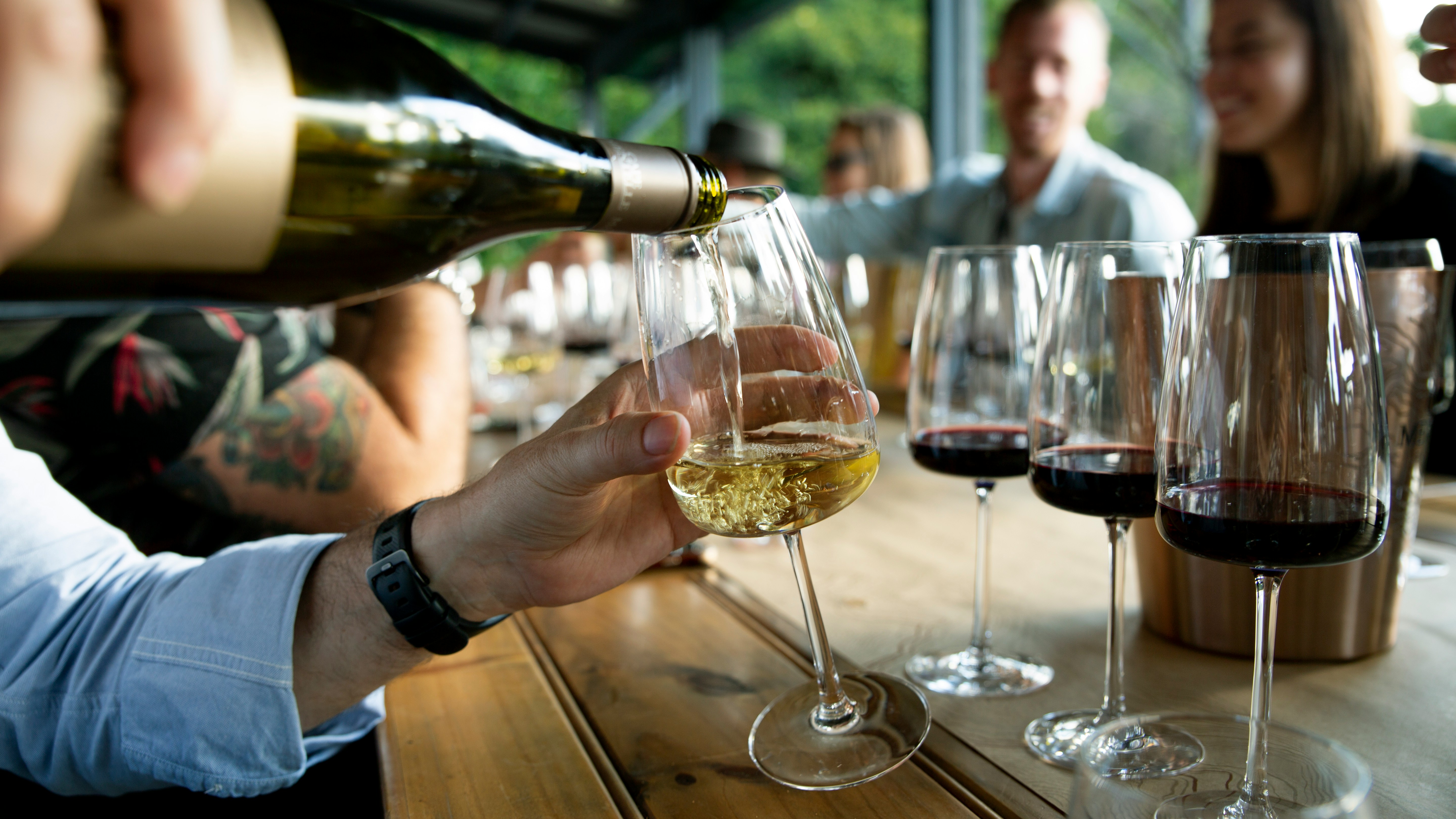 White wine being poured into a glass at a tasting — understanding sulphites in wine