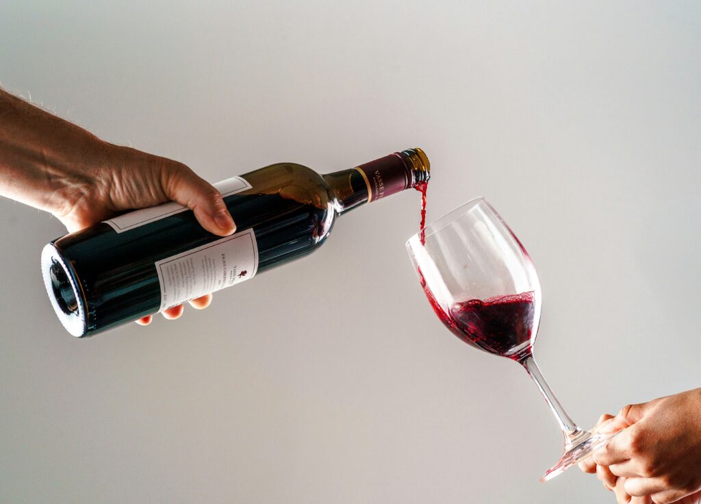 Red wine being poured into a glass — picking low-histamine bottles is key to drinking red wine without feeling stuffy