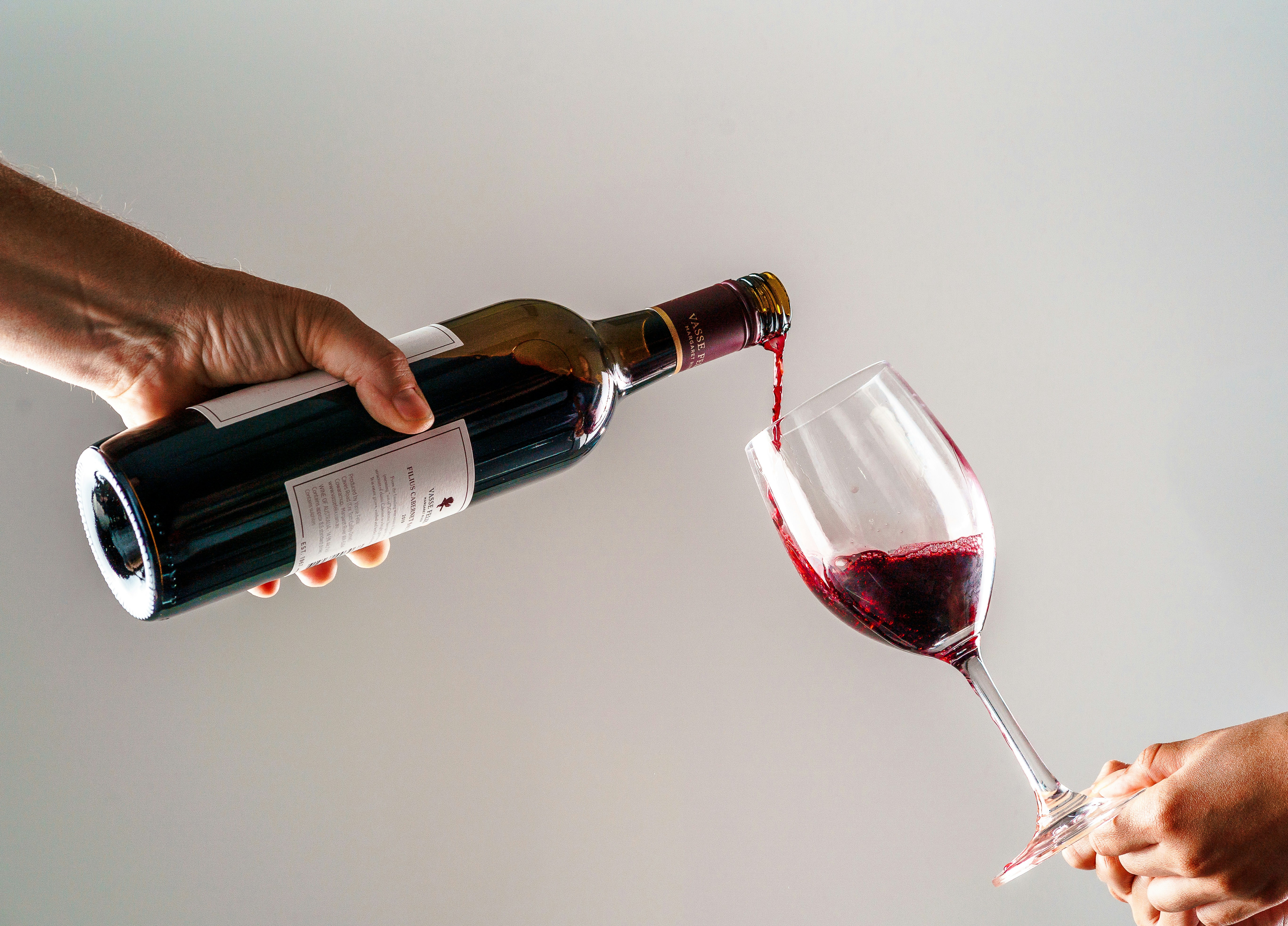 Red wine being poured into a glass — picking low-histamine bottles is key to drinking red wine without feeling stuffy